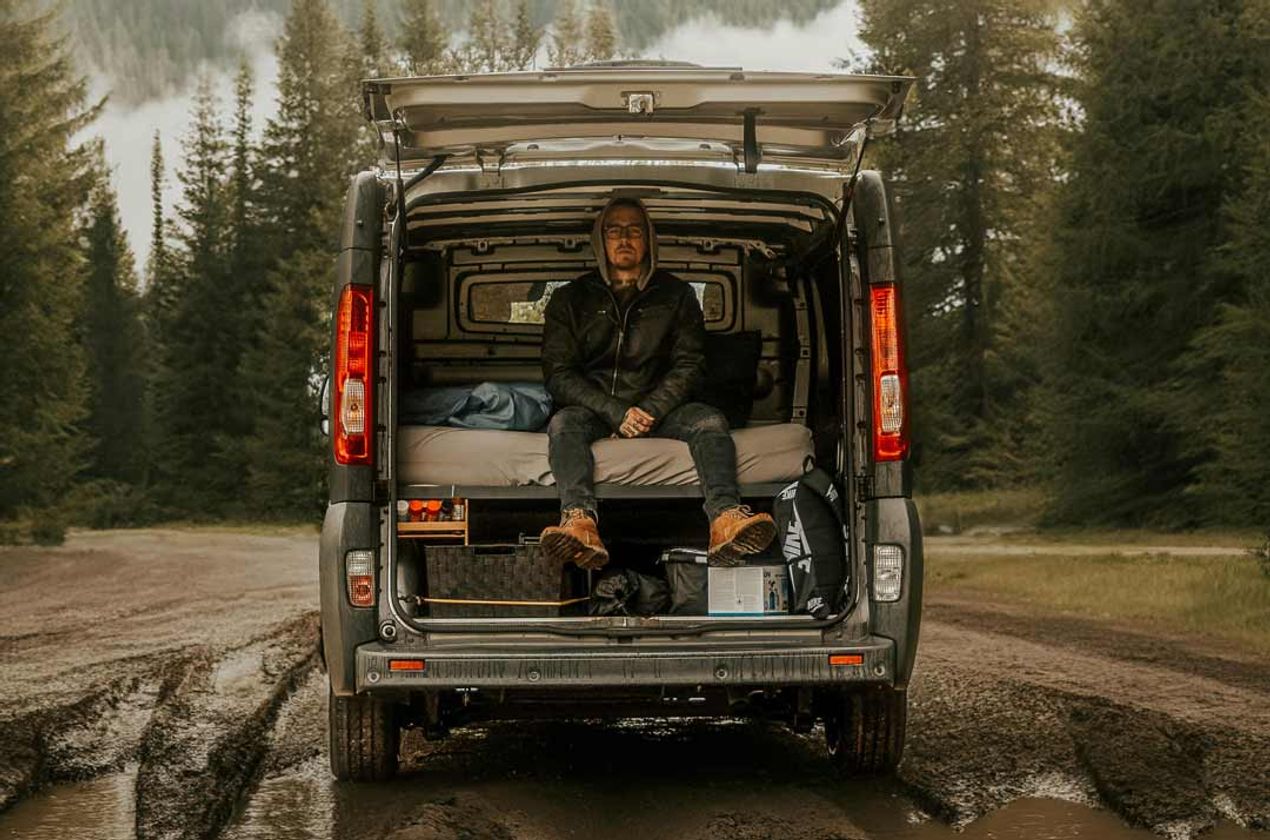 Single guy boondocking in the back of his camper van.