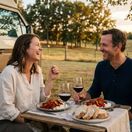 A couple enjoying dinner during their RV stay