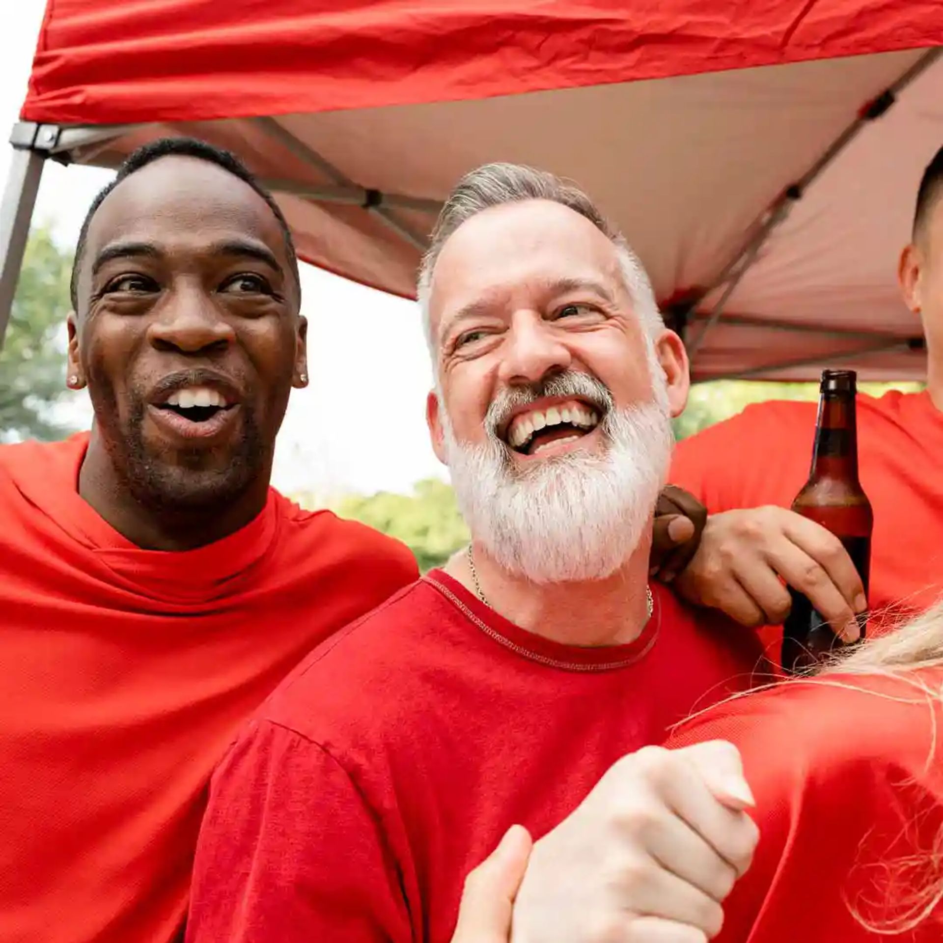 A couple of men enjoying tailgating. 