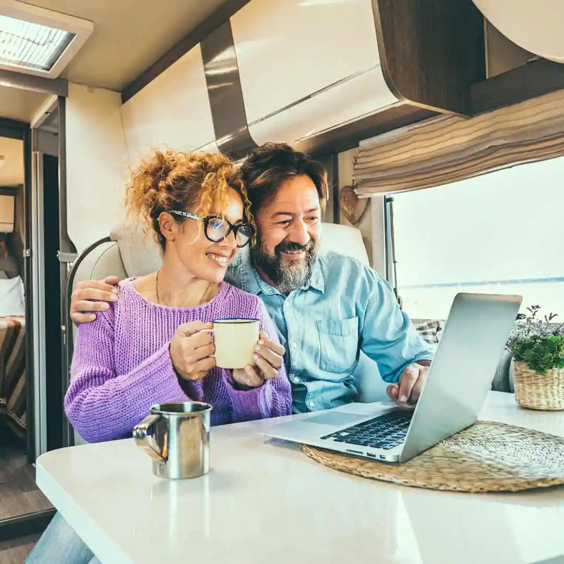 Couple working inside their RV. 