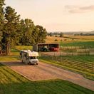 Class C parked at a farm on a gravel pad