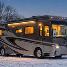 Class A RV parked in the snow at a CurbNTurf Host property.