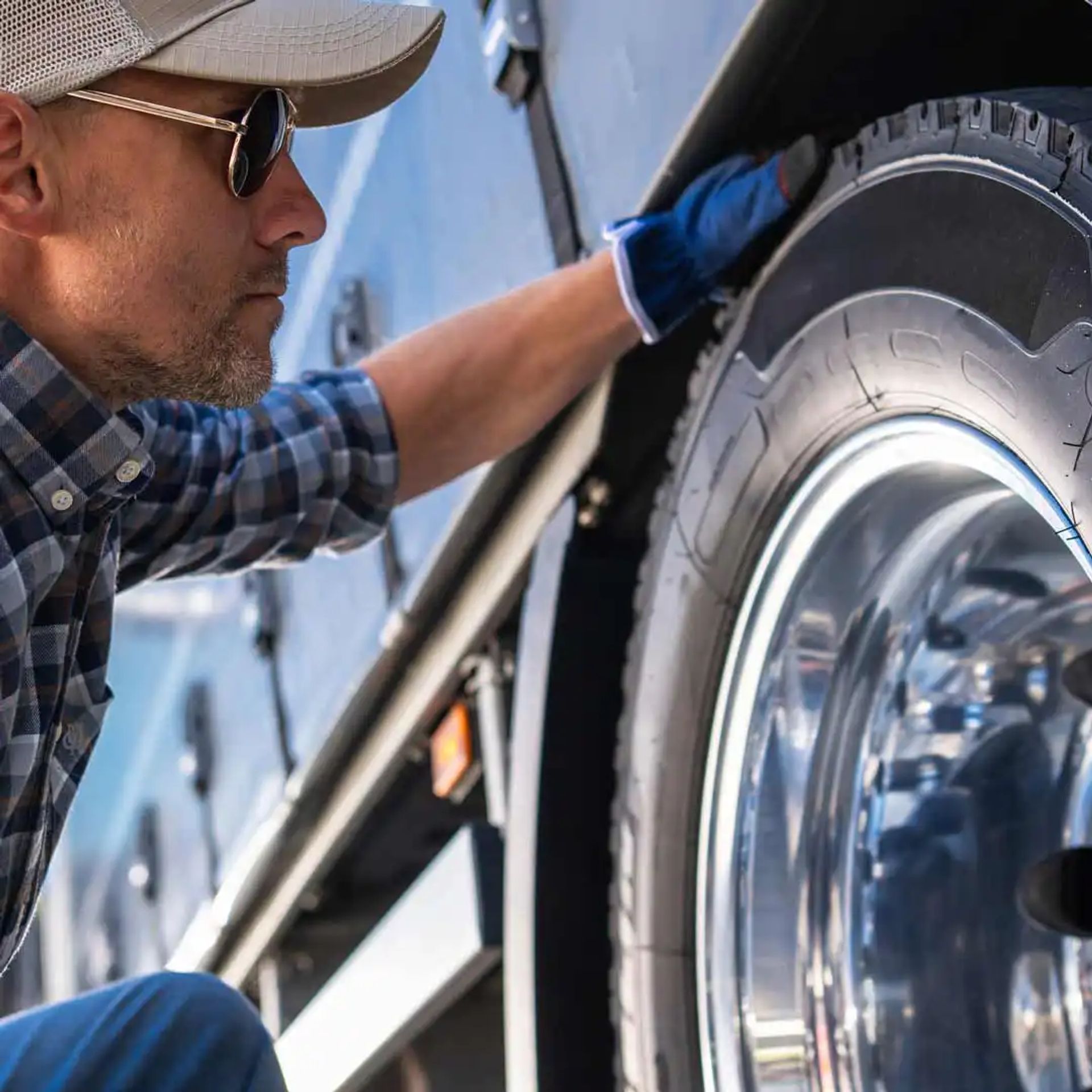 Man checking the tire pressure on his RV