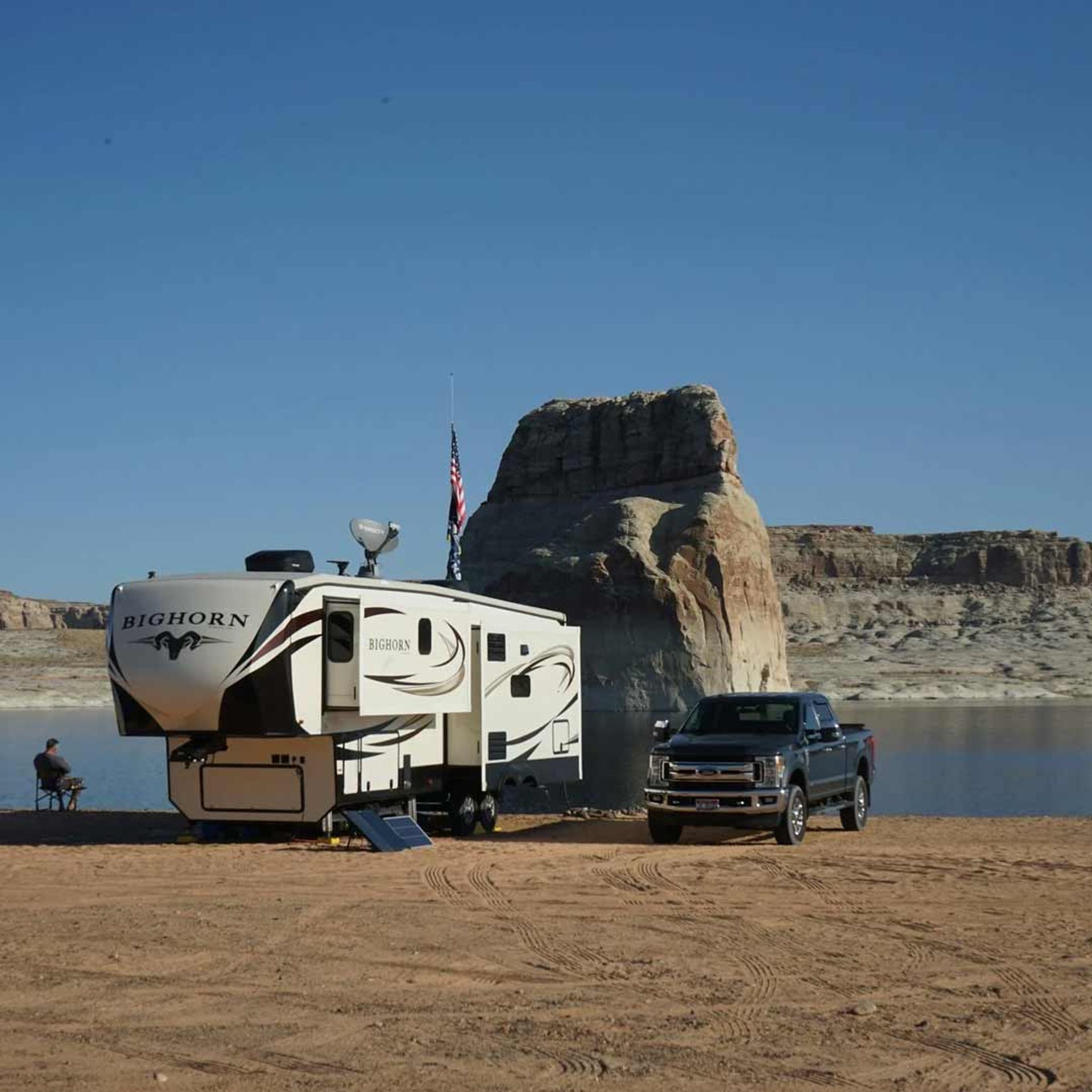 Fifth-wheel camper boondocking near the waterfront in Arizona.
