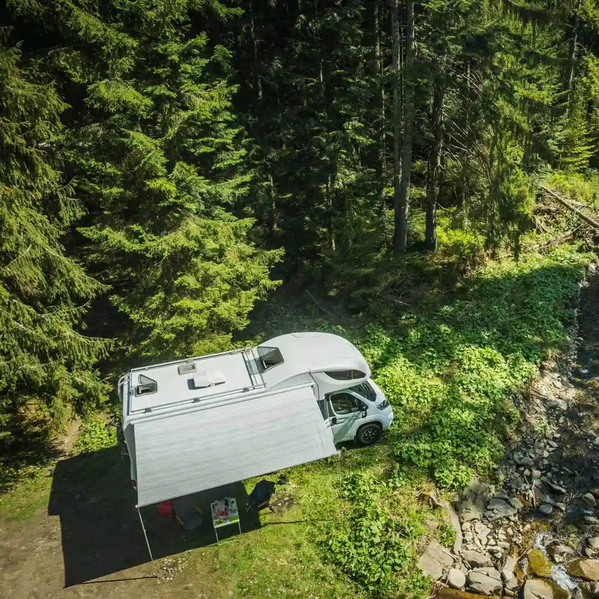 RV near a stream in the forest