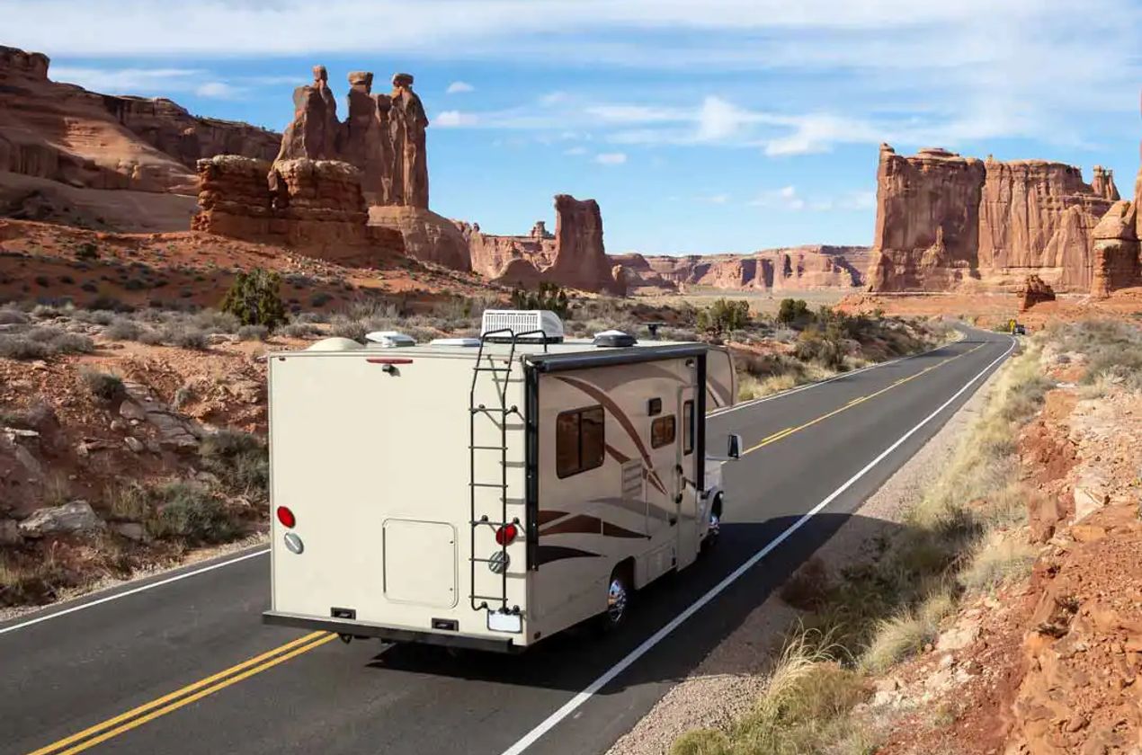 Class C RV driving on the road in southern Utah